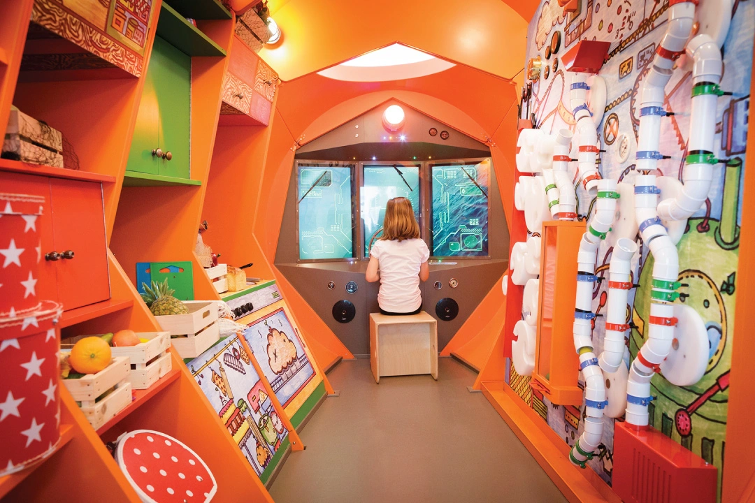 Child in a room playing with toys